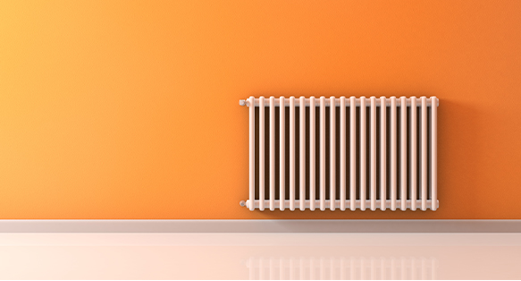 radiator fitted to orange wall