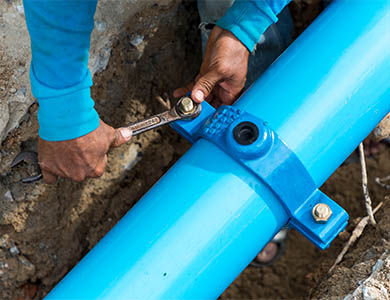 photo of a large blue pipe being fitted.
